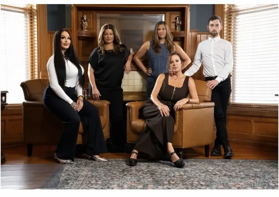 The Kippy Ellis Group team together in a wood-paneled office